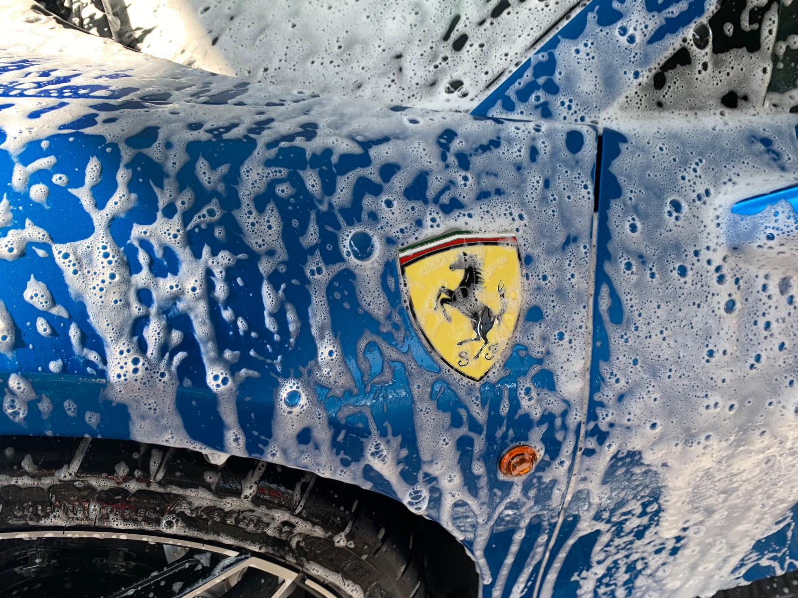 Car covered in foam during a hand wash at Prestigious in Orlando