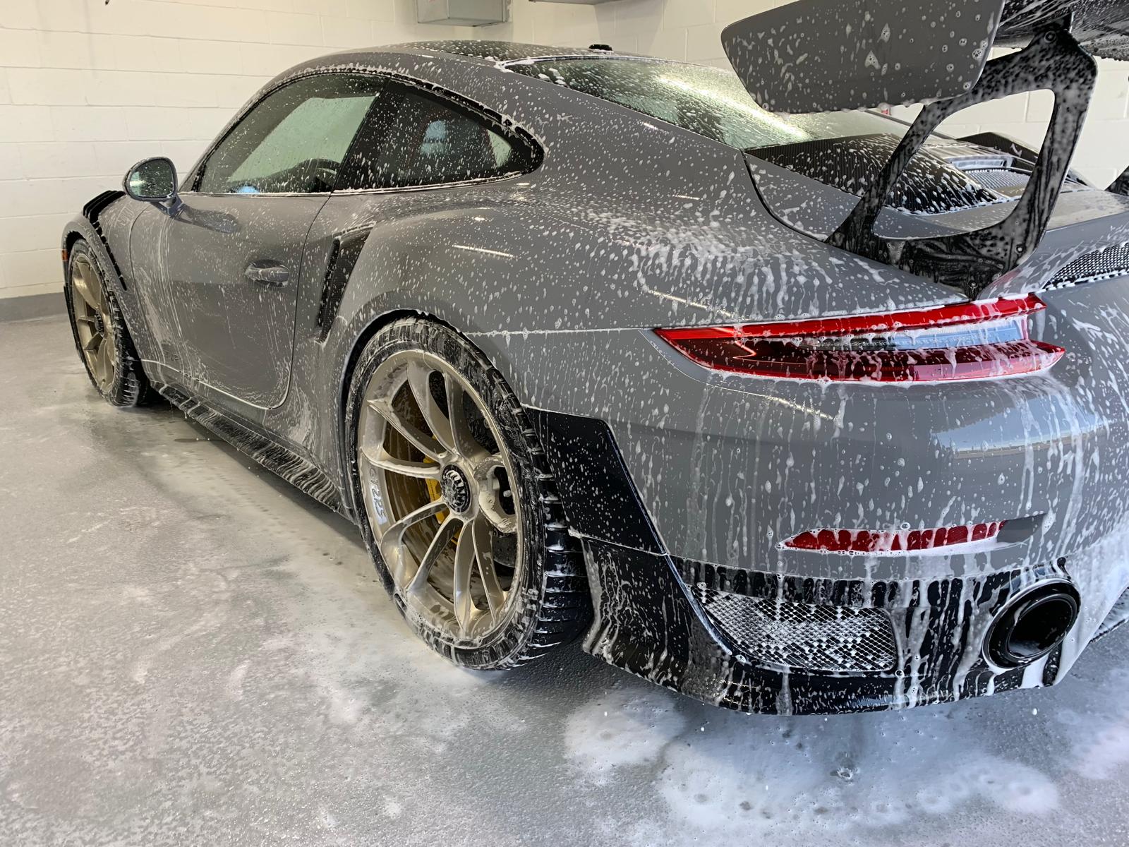 Snow foam rinse on a sedan