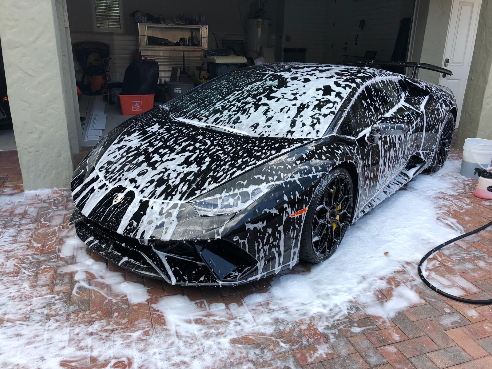Wheels and tires being cleaned during a wash